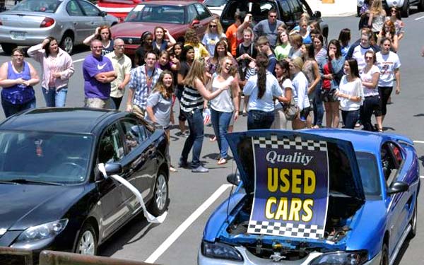 women group in used car dealer lot