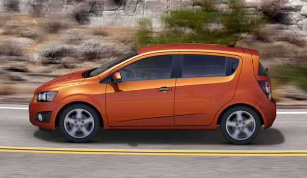 orange 2013 chevrolet sonic Exterior - in motion.